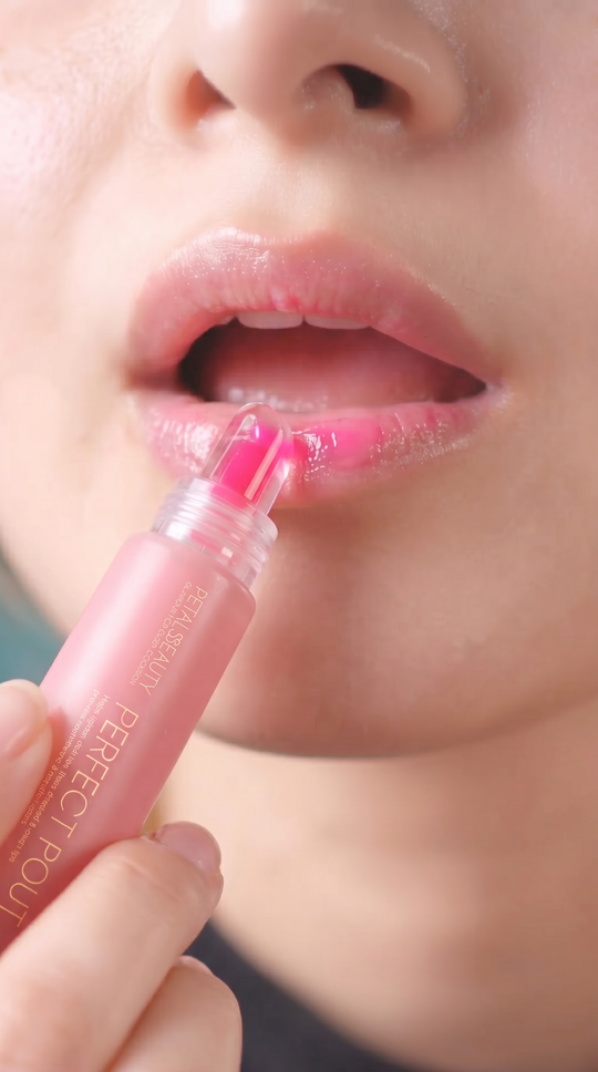 Perfect Pout Pink Petals lip gloss swatch showing glossy rosy pink finish
