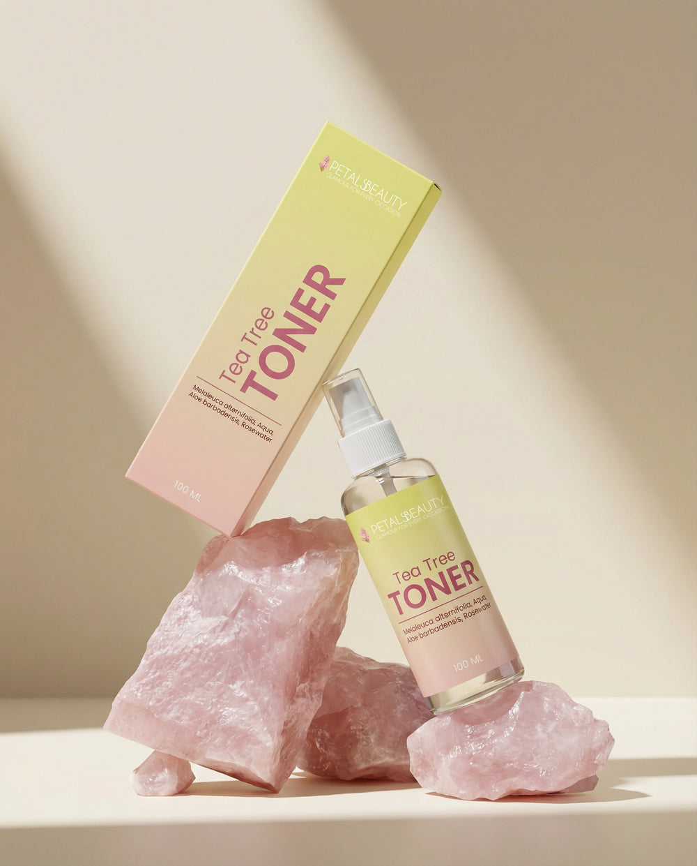Tea tree toner bottle and box on pink rocks with a soft beige background