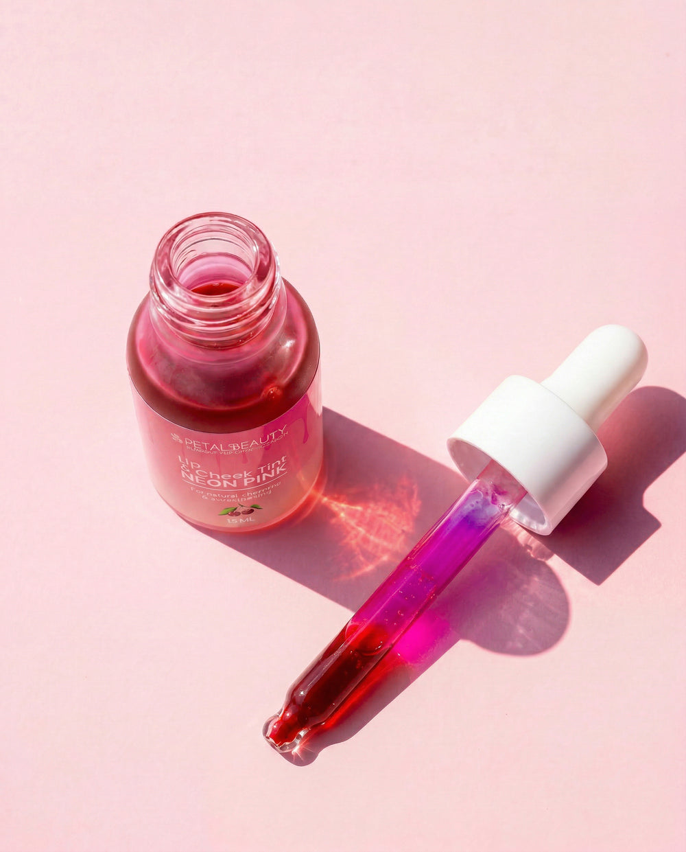 Neon Pink lip and cheek tint bottle with bright hot pink formula