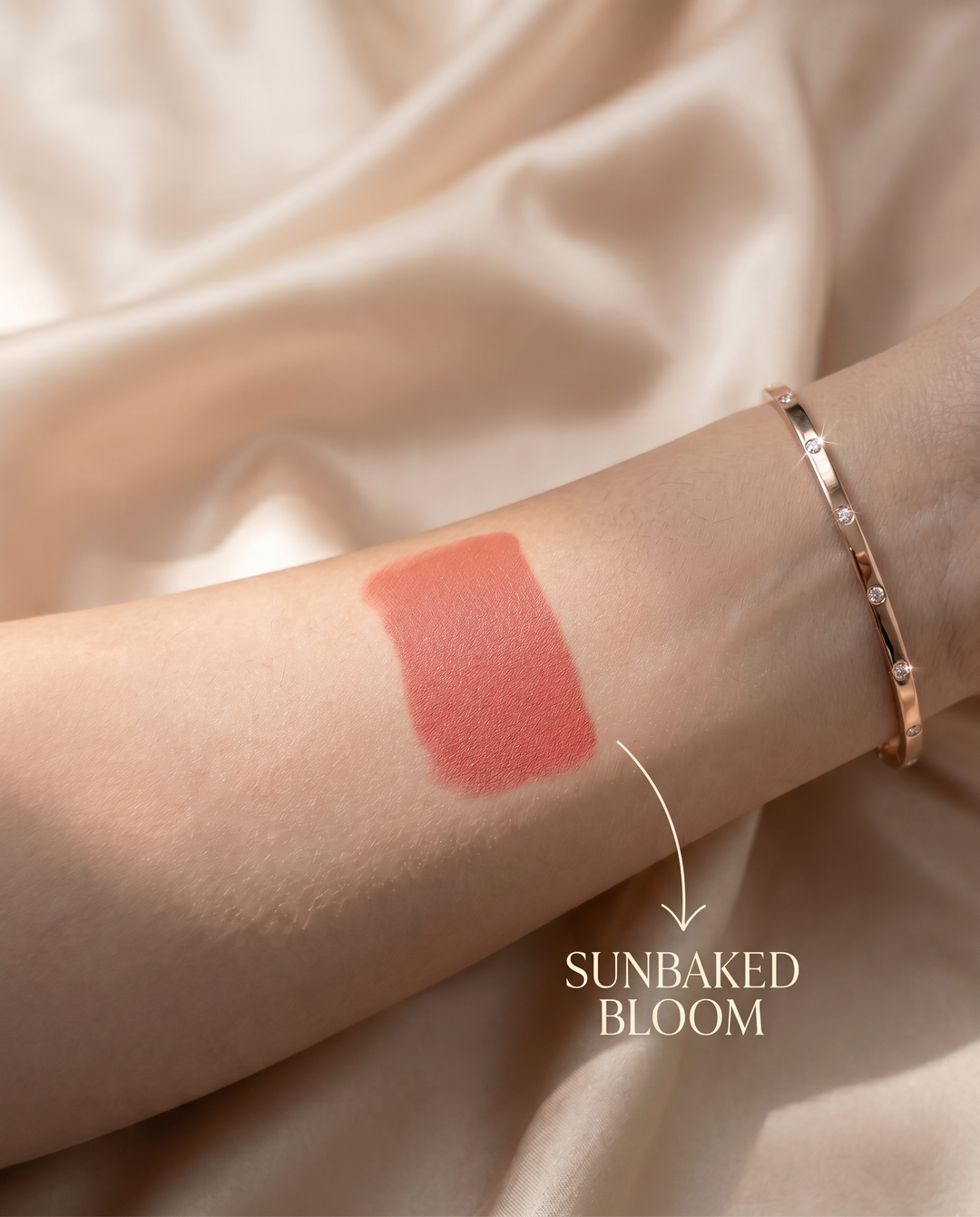 Sunbaked Bloom blush swatch blended on wheatish skin showing a warm brick red flush
