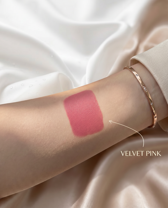 Pink velvet liquid blush swatch blended on skin showing dewy natural finish